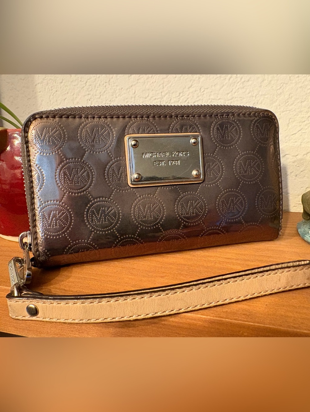 Michael Kors Embossed Logo Wristlet with silver Plaque